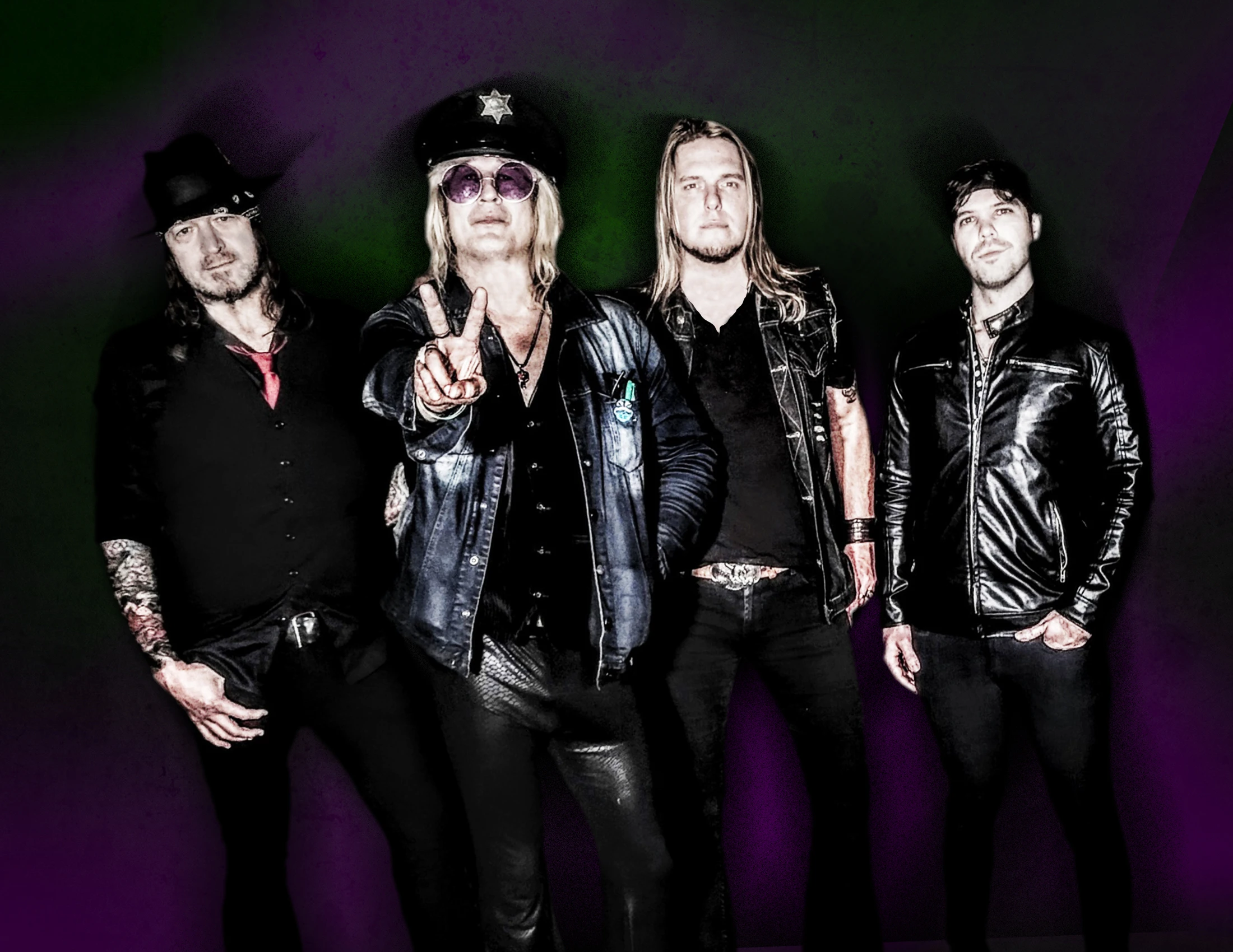 Image of the rock band Enuff Z' Nuff standing together with dark purple and green background. Lead singer Chip Z'Nuff with hand up in a peace sign.